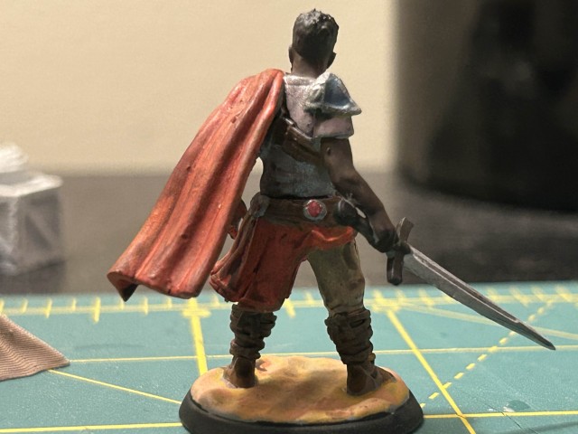 Same miniature swordsman turned around to see his back.